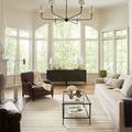 Chris Natural Sage Rug displayed in bright living room under coffee table with leather and fabric chairs