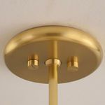 Close-up of aged brass ceiling mount and rod attachment