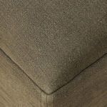 Close-up of linen slipcover skirt and oak leg with slit opening detail at corner