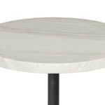 Close-up of the white marble top showing subtle veining and smooth edge