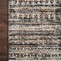 Close-up of Theia Grey / Multi Rug corner on dark wood floor showcasing refined fringe border and detailed patterning