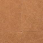 Macro shot of leather upholstery showcasing fine grain texture and cross stitching