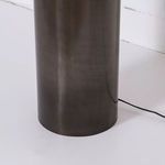 Close-up of lower dark iron portion of cylindrical lamp base showing ombre gradient