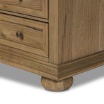 Lower corner showing bun foot detail and wood grain on nightstand base