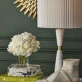 Single Edelmar White Table Lamp styled on console alongside white floral bouquet and shoe sculpture