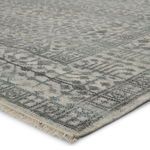 Close-up angled view showing carved texture and fringe along rug's edge