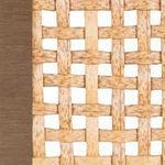 Close-up detail of woven rattan pattern with natural finish and light wood side trim