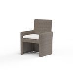 Three-quarter angle of Coronado Dining Chair highlighting armrest curve and seat cushion thickness