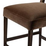 Close-up of the square seat corner highlighting velvet fabric and wooden frame detail
