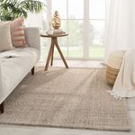 Sutton area rug styled in bright living room under sofa and side table with plants and natural light