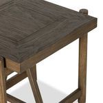 Low angle close-up of triangular support between rounded wood legs
