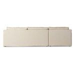 Back view of sectional showing smooth, seamless slipcover on lower frame