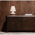 Dell table lamp styled on a dark wood dresser against a dark wood wall