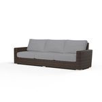 Montecito Sofa featuring rich cognac multi-colored resin wicker frame with light gray cushioned seating for outdoor use