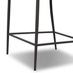 Angled rear-side view showing cushion ties and woven seat underside