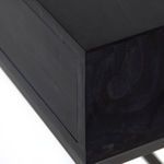 Detail of black wood corner showing smooth surface and wood joinery on Trey Console Table