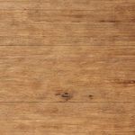 Close-up of wood surface texture showing distressed oak grain and natural wood knots