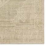 Zoomed-in corner of the rug highlighting geometric border and distressed vintage medallion pattern