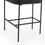 Close-up of matte black iron legs and rectangular footrest detail