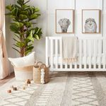 Top-down shot of rug decorated with wooden blocks and lamb stuffed animal in nursery