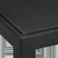 Close-up of black lacquered linen texture on table corner and leg