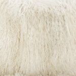 Macro view focused on tightly curled, light cream Mongolian fur fibers