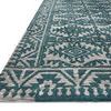Low-angle close-up of rug corner highlighting the thick pile and pattern texture
