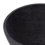 Close-up inside rim of pedestal bowl showing smooth matte black wood texture and wood grain