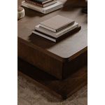 Detail shot of Casey Coffee Table corner showing wood grain texture and rounded edges with stacked books