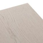 Diagonal close-up of tabletop surface showing subtle wood grain pattern in pale finish