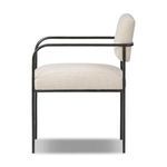 Side profile of Fenn Dining Chair showing depth of seat cushion and backrest against iron frame