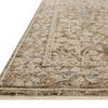 Close-up angled view showing the rug’s fringed edge and detailed floral border design