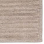 Close-up corner focusing on the ridged border texture and plush center pile of the rug