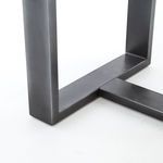 Close-up of bottom corner connection of dark iron base on Mercury Console with smooth metal finish