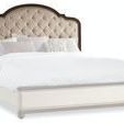 Front view of headboard and matching upholstered bed frame with nailhead trim on plain white background