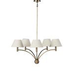 Linus Chandelier hanging above dark wood dining table with natural light through window