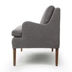 Profile side view highlighting banquette's gently curved armrest and tapered wooden legs