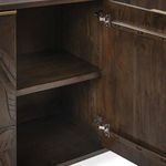 Interior close-up showing adjustable shelf and metal hinges inside the storage cupboard