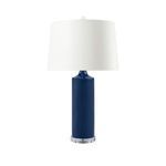 Conniston Lamp with navy blue glazed ceramic column, curved neck, clear round base, and white drum shade