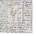 Detailed macro view of medallion and border patterns featuring light blue and gray tones