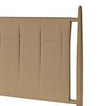 Side close-up of top portion of the headboard showing cord wrapping and finial top
