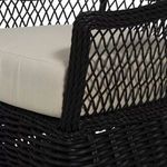 Close-up on armrest twisted resin wicker texture and beige seat cushion