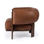 Side slightly angled close-up on the chair’s padded leather arm and wood detail