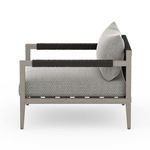 Side view highlighting armrest wrapping texture and cushion thickness