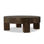 Round table viewed at a slight side angle showcasing four chunky wooden legs and rustic wood grain