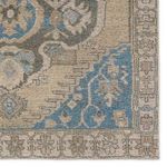 Close-up of corner highlighting detailed floral motifs in blue and beige border