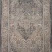 Close-up focus on the rug’s dark side showing muted blue and gray tones with subtle detailing