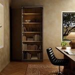 Ivy Bookcase styled with books and decorative vases inside a cozy study room with leather swivel chair and window