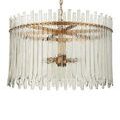 Angled front of chandelier emphasizing staggered, curved glass bars and warm metal frame details