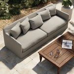 Outdoor setting with Dade Faye sofa on stone patio next to wooden coffee table and plants